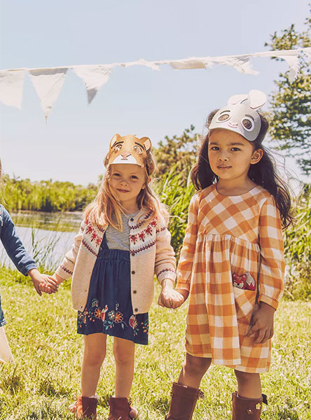 3 girls wearing dresses and holding hands