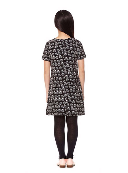 girl in black and white pattern dress - rear view