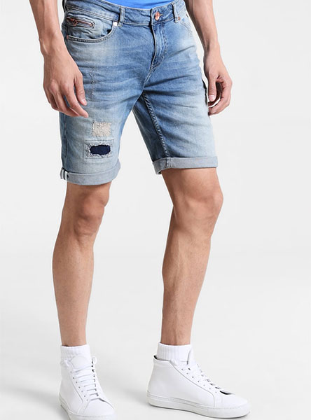 man in blue jean shorts