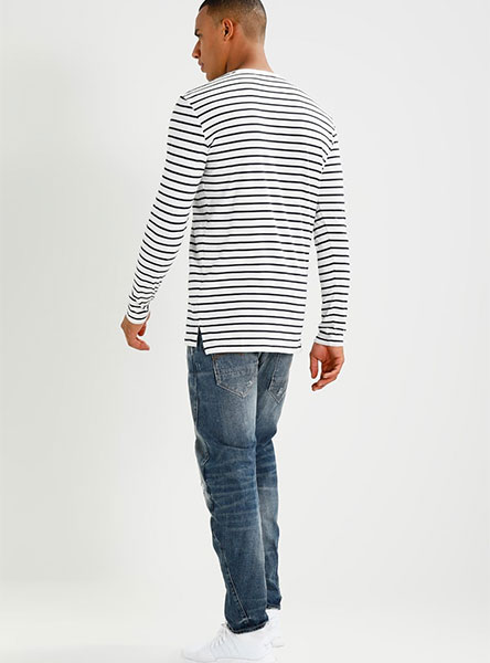 man in blue jeans and striped shirt