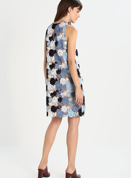 woman in blue and white print dress - rear view